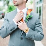 Groom on Wedding Day in Grey Suit and Orange Boutonniere