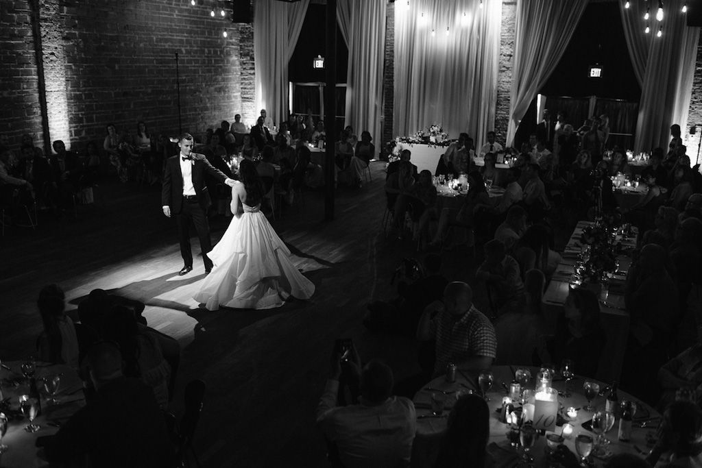 Wedding Reception First Dance Portrait with Exposed Brick Wall and Hanging Edison Bulb Lights | Unique Downtown St Pete Wedding Venue NOVA 535