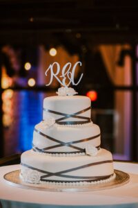 White wedding cake with laser cut topper