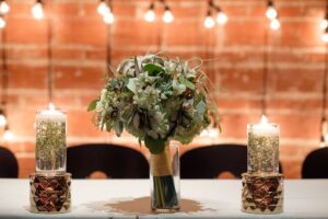 Greenery floating candle centerpiece at sweetheart table