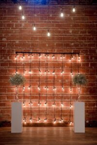 Industrial string light and baby's breath arrangement ceremony decor