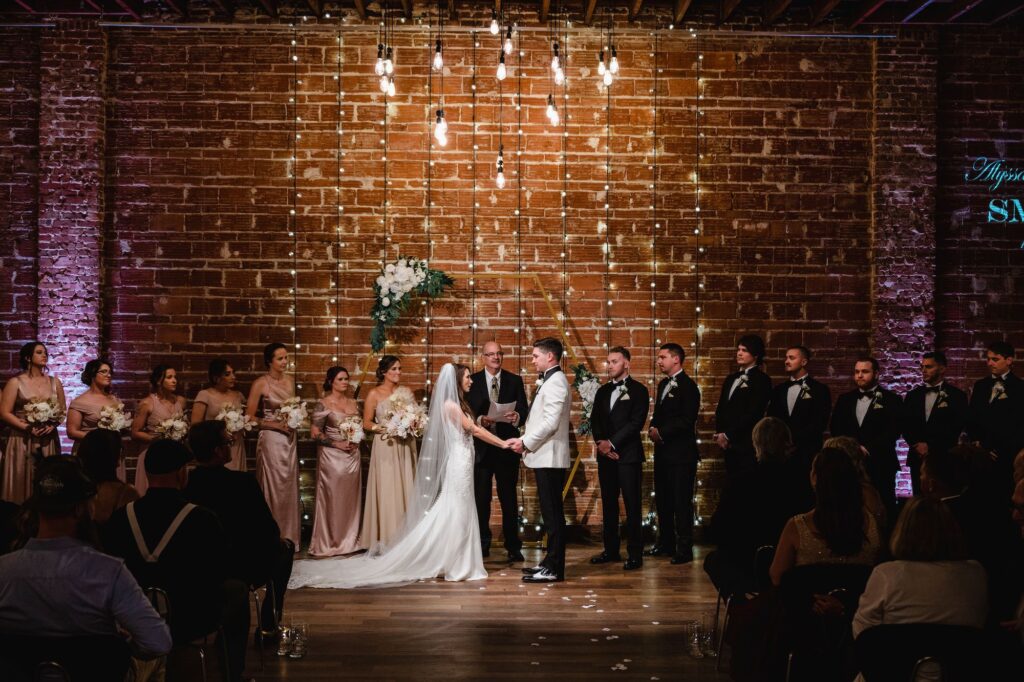 1920s Gatsby Inspired Wedding Ceremony with Brick Wall and String Light Backdrop | Downtown St Pete Venue Nova 535