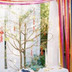 Vietnamese wedding ceremony with colorful streamer backdrop