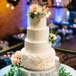 White Four-Tier Buttercream Wedding Cake with Peach and White Flowers and Mr. Mrs Cake Topper | Unique DTSP Wedding Venue NOVA 535