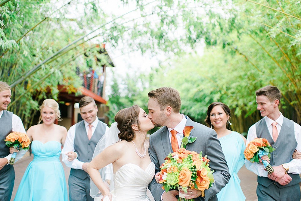 Kissing Couple Turquoise and Tangerine Outdoor Courtyard Wedding at historic Downtown St. Pete venue NOVA 535