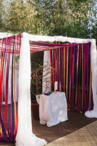 Vietnamese wedding ceremony with colorful streamer backdrop