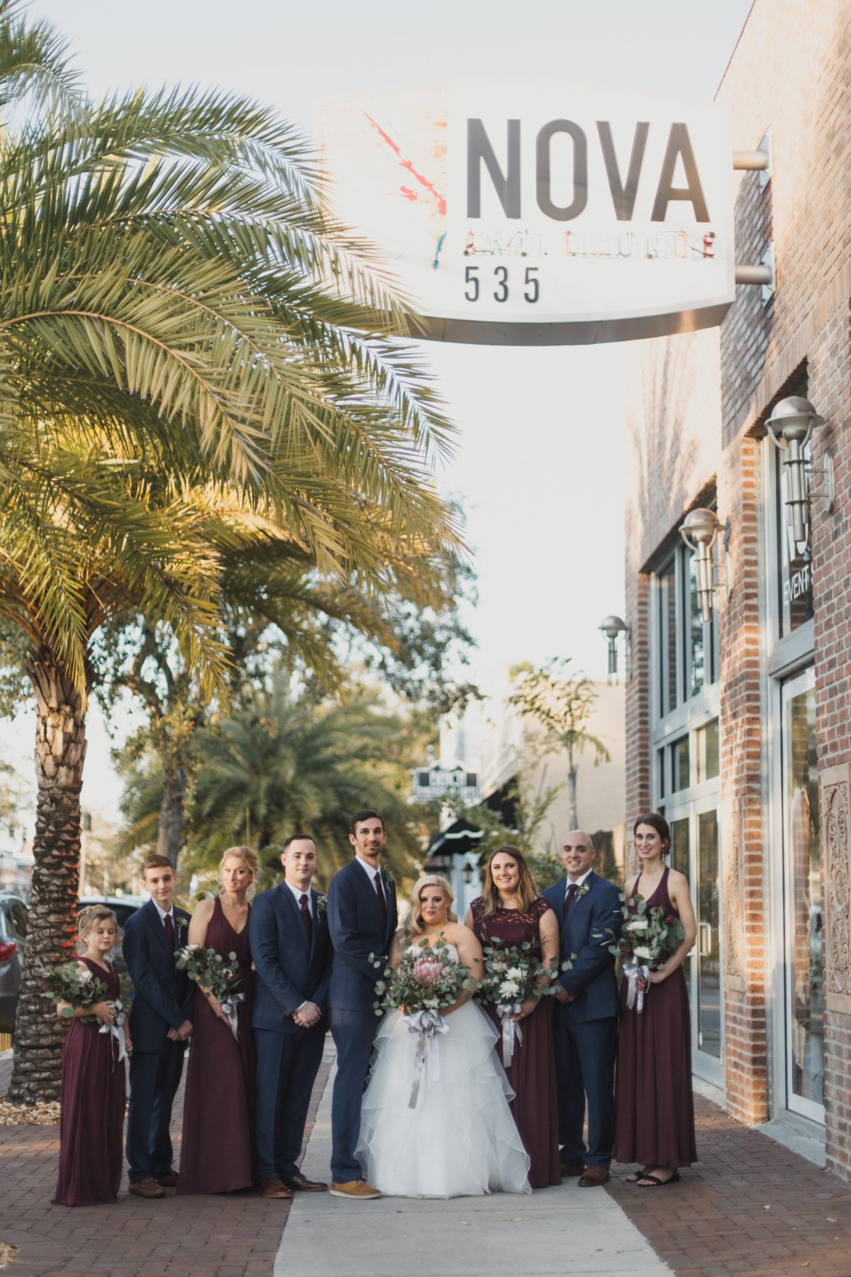 Burgundy and navy wedding party outside NOVA 535 in St. Pete